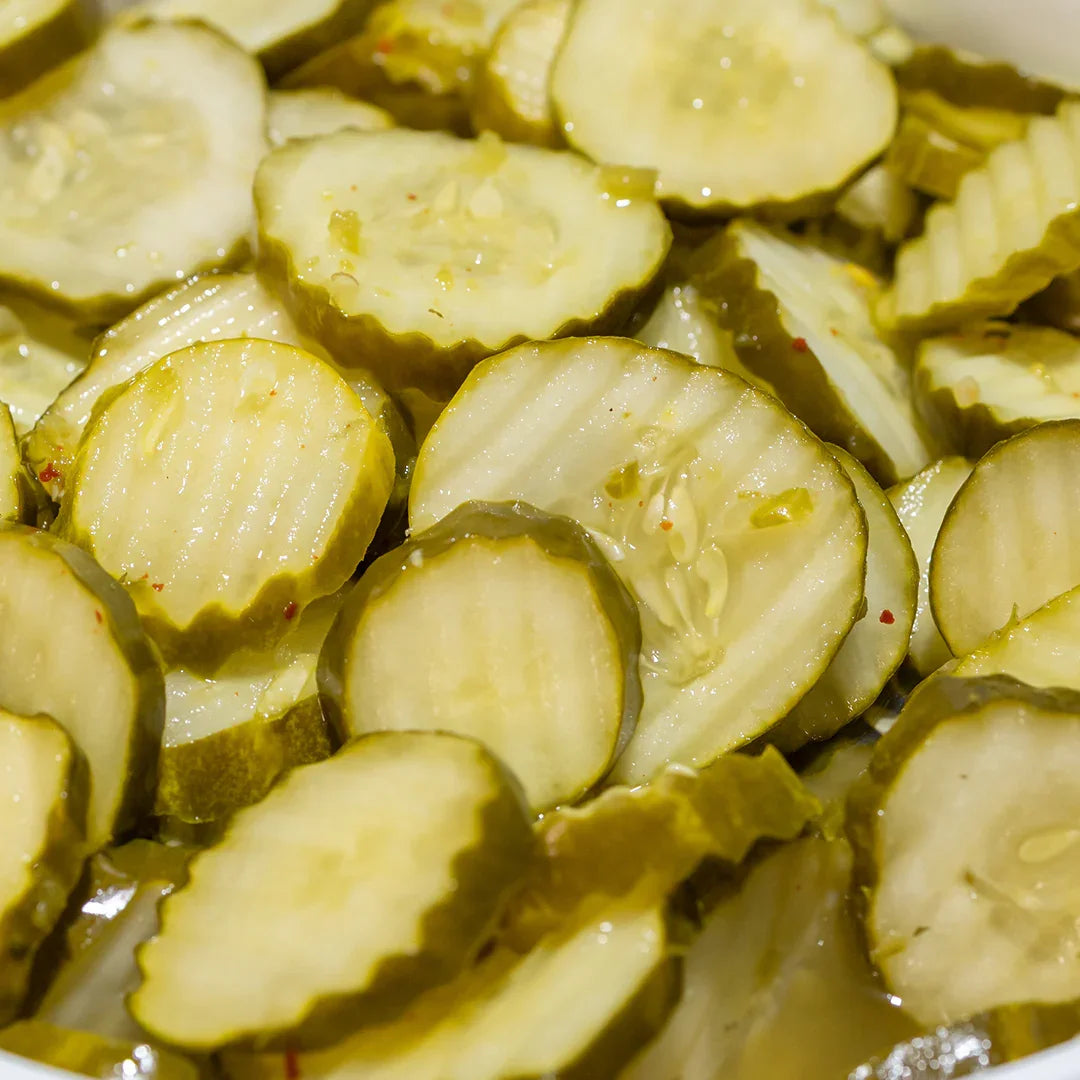 Close-up of spicy ranch pickles with ridged edges and visible seasoning flakes